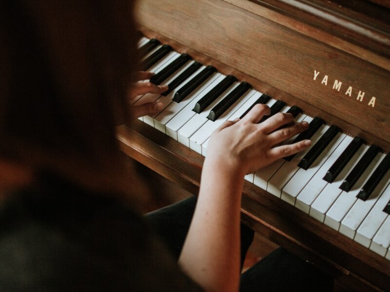 woman playing Yamaha piano