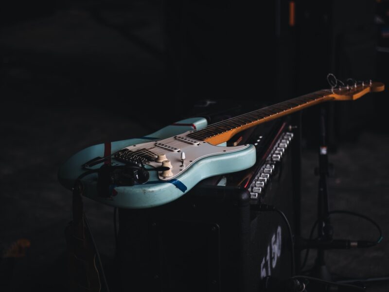 teal and brown electric guitar