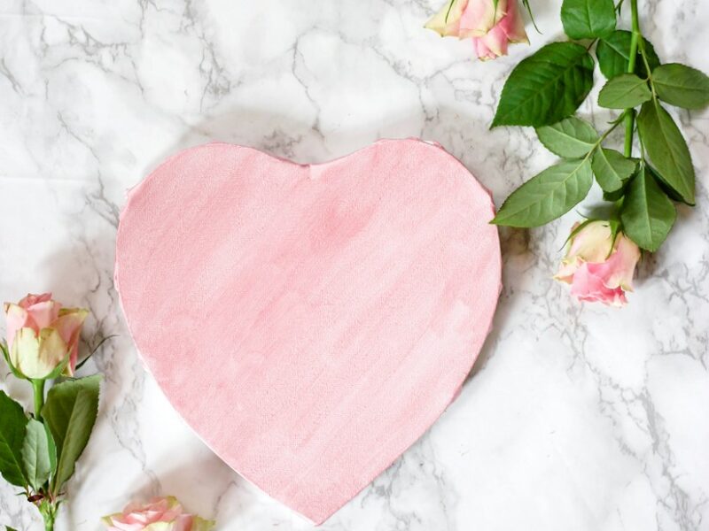 pink heart shaped textile on white floral textile