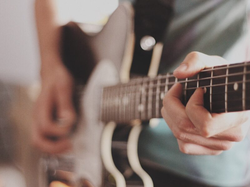 person playing electric guitar