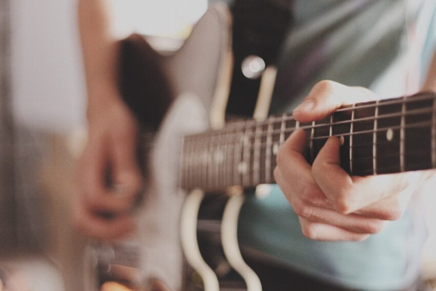 person playing electric guitar