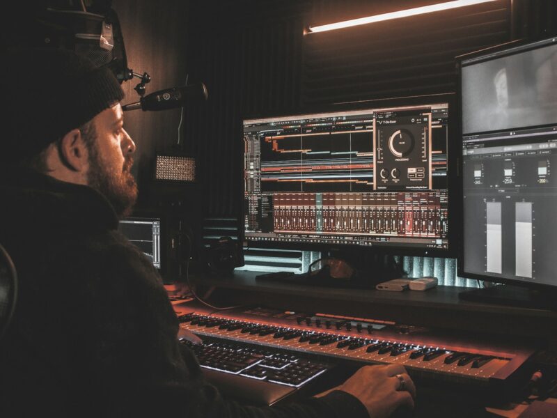 man in black long sleeve shirt playing audio mixer