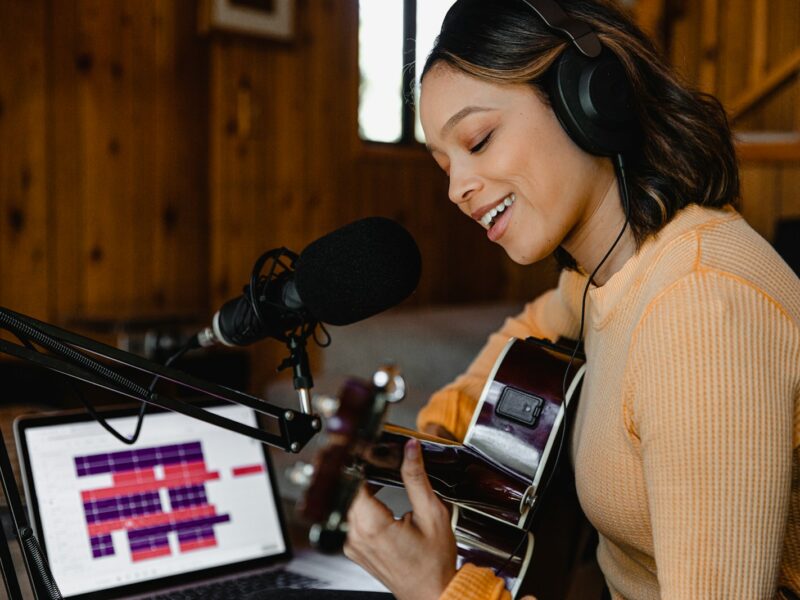 woman in brown sweater wearing headphones