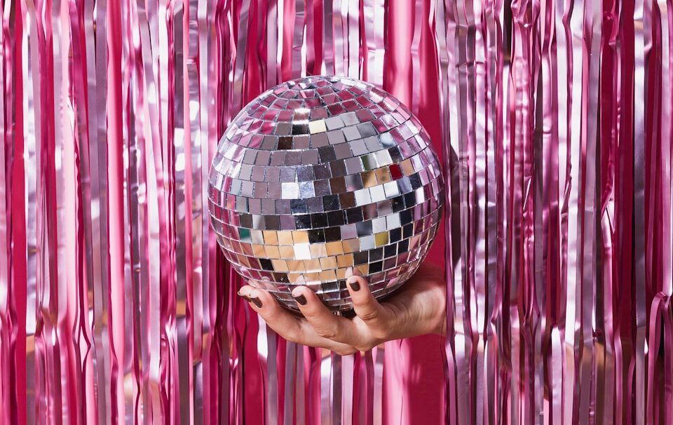 person holding red and black ball